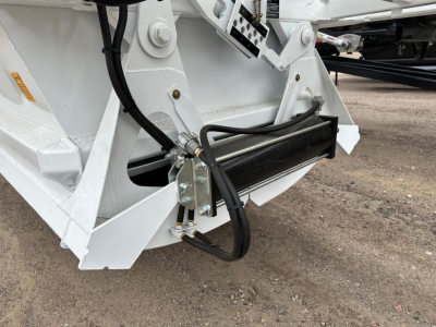 Ranco LW21-40 dump trailer hitch area showing hydraulic lines and black protective guard on white frame.