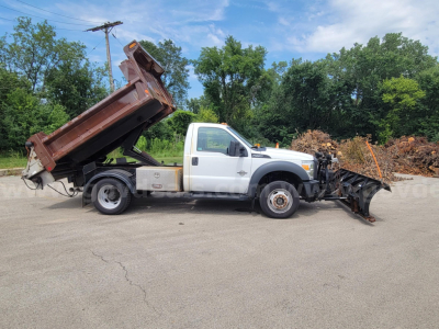 Ford F-550 dump truck with a plow attachment in front, white cab and brown dump body, side view, used condition.
