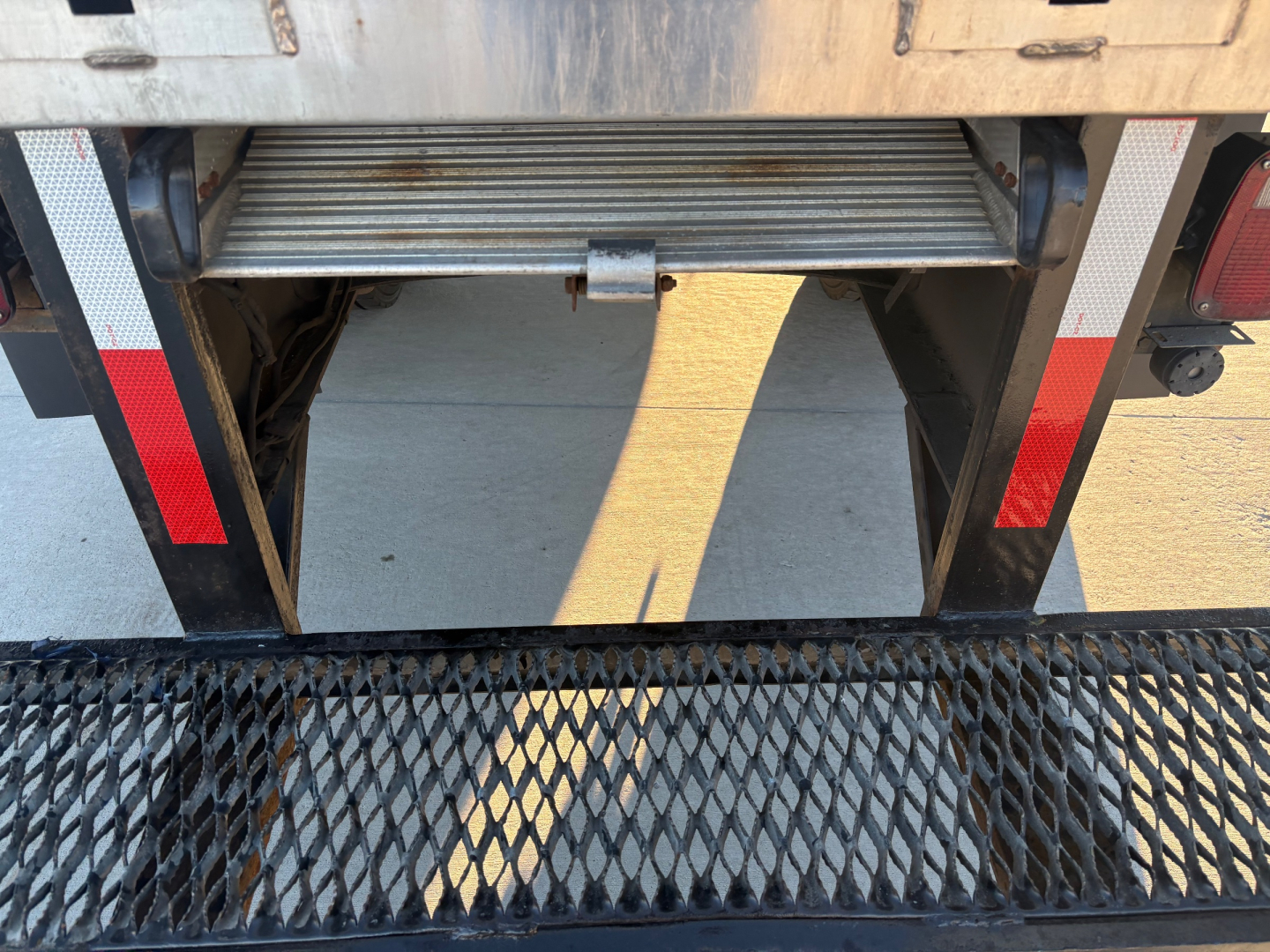 Truck rear view showing retract step and cargo area of a 2021 International MV607 with stock number 0632645, VIN 3HAEUMML4ML389414, parked on a surface.