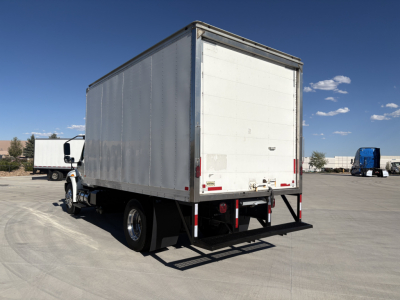 Box truck rear and left side view showing cargo box and rear stairs with bumper and taillights.