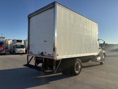Box truck rear three-quarter view showing cargo box and rear bumper with tail lights, International MV607 likely truck chassis with box body