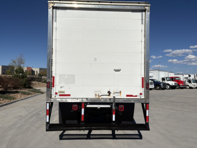 Box truck rear view showing white cargo area with bumper guards and taillights.