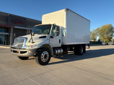 Box truck side view showing 2021 International MV607 with large white box cargo area and dual rear wheels.