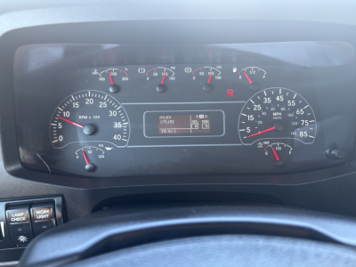 Dashboard view of a 2021 International MV607 instrument cluster showing RPM gauge, speedometer, fuel gauges, and an odometer/engine info panel.