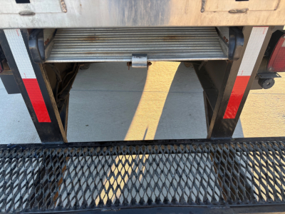 Truck rear view showing retract step and cargo area of a 2021 International MV607 with stock number 0632645, VIN 3HAEUMML4ML389414, parked on a surface.