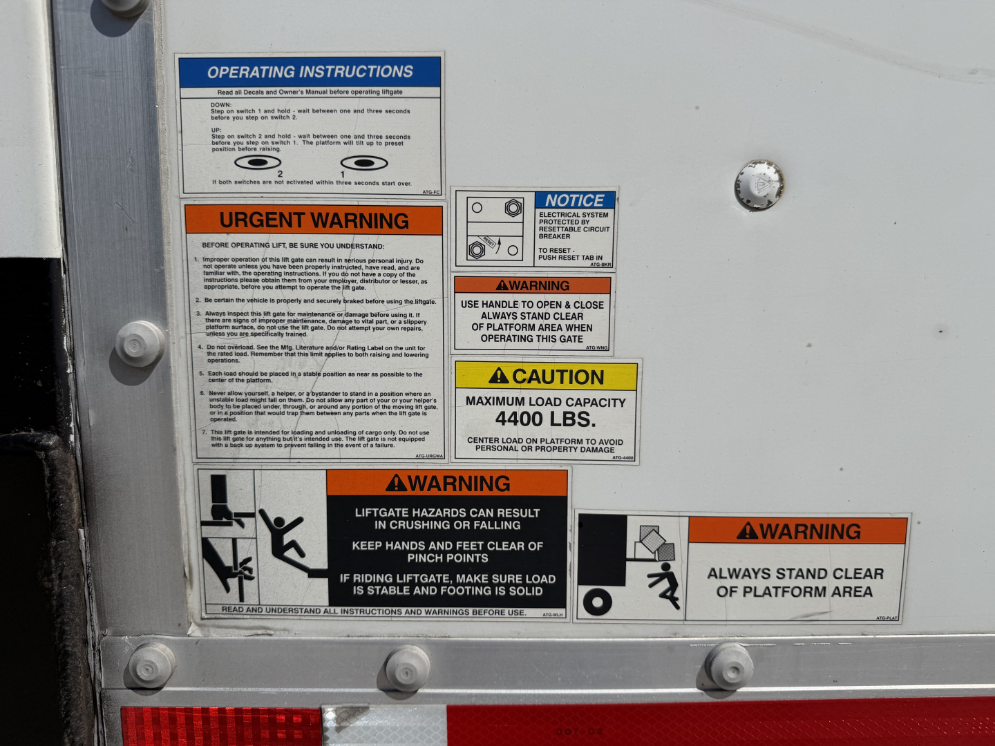 Panel of operating instructions and warnings on a Kenworth T680 truck side showing multiple labels including urgent warning and caution signs.