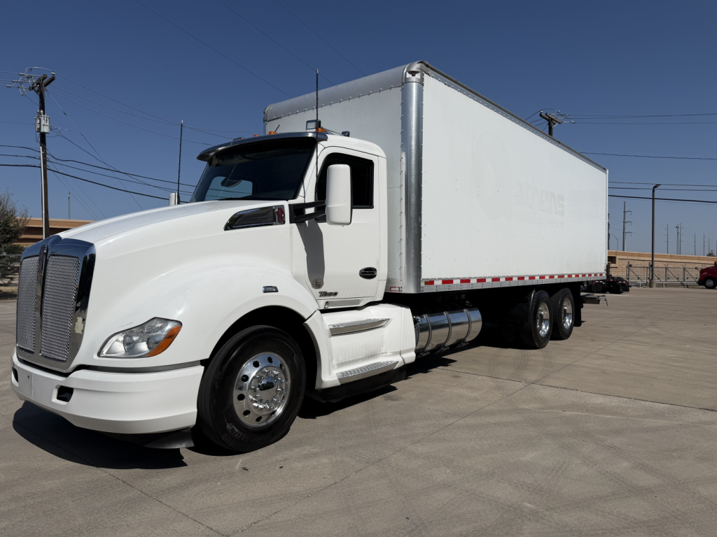 Kenworth T680 box truck with white cab and cargo trailer, no visible text readable on sides or logo details.