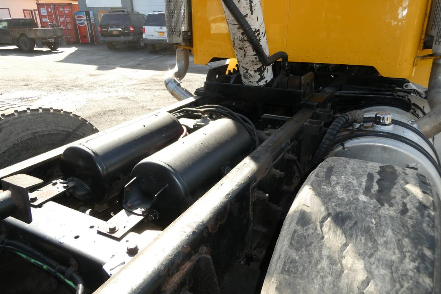Peterbilt 357 dump truck rear chassis showing dual air tanks and drive components.