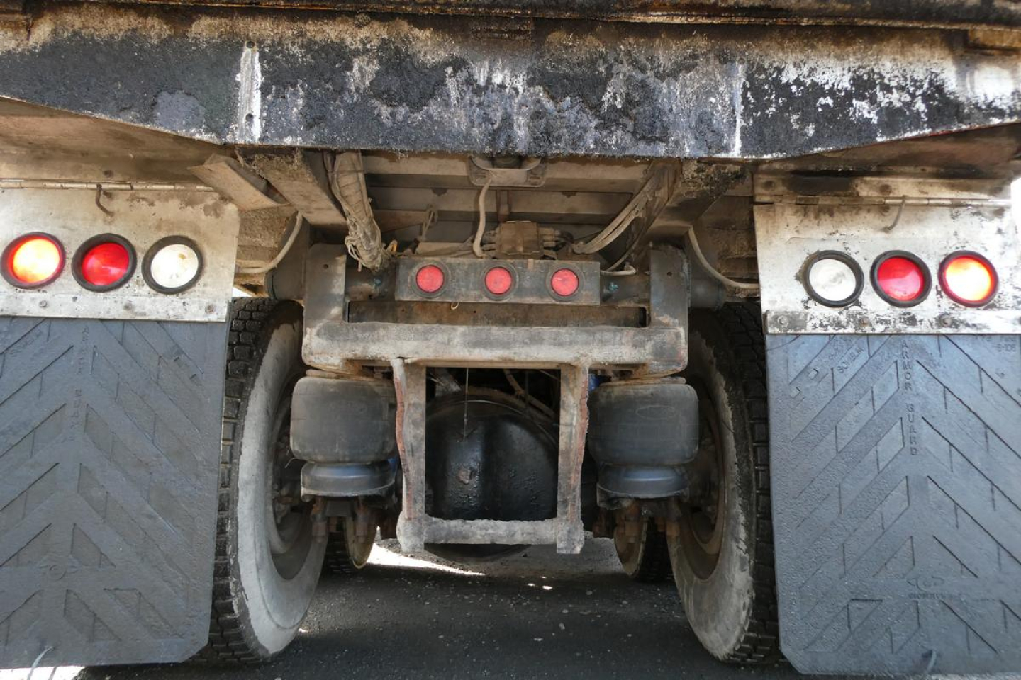Peterbilt 357 rear of truck showing chassis and dual rear wheels with mudflaps and taillights; central hitch and PTO area visible.