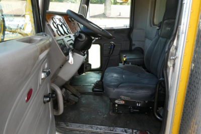 Cab interior of 2006 Peterbilt 357 dump truck showing driver seat and dashboard area.