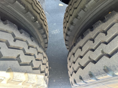 Dual rear wheels of a new Jet Side Dump trailer showing heavy-duty interleaved tires with tread pattern.