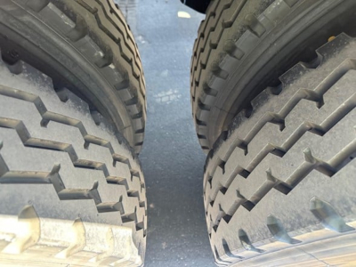 Dual wheel hubs and truck tires view for a 2026 Jet Side Dump trailer showing heavy tread tires and wheel rims.