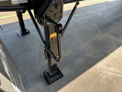 Trailer landing gear with support leg and hydraulic cylinder showing labels and wiring in a Jet Side Dump trailer.