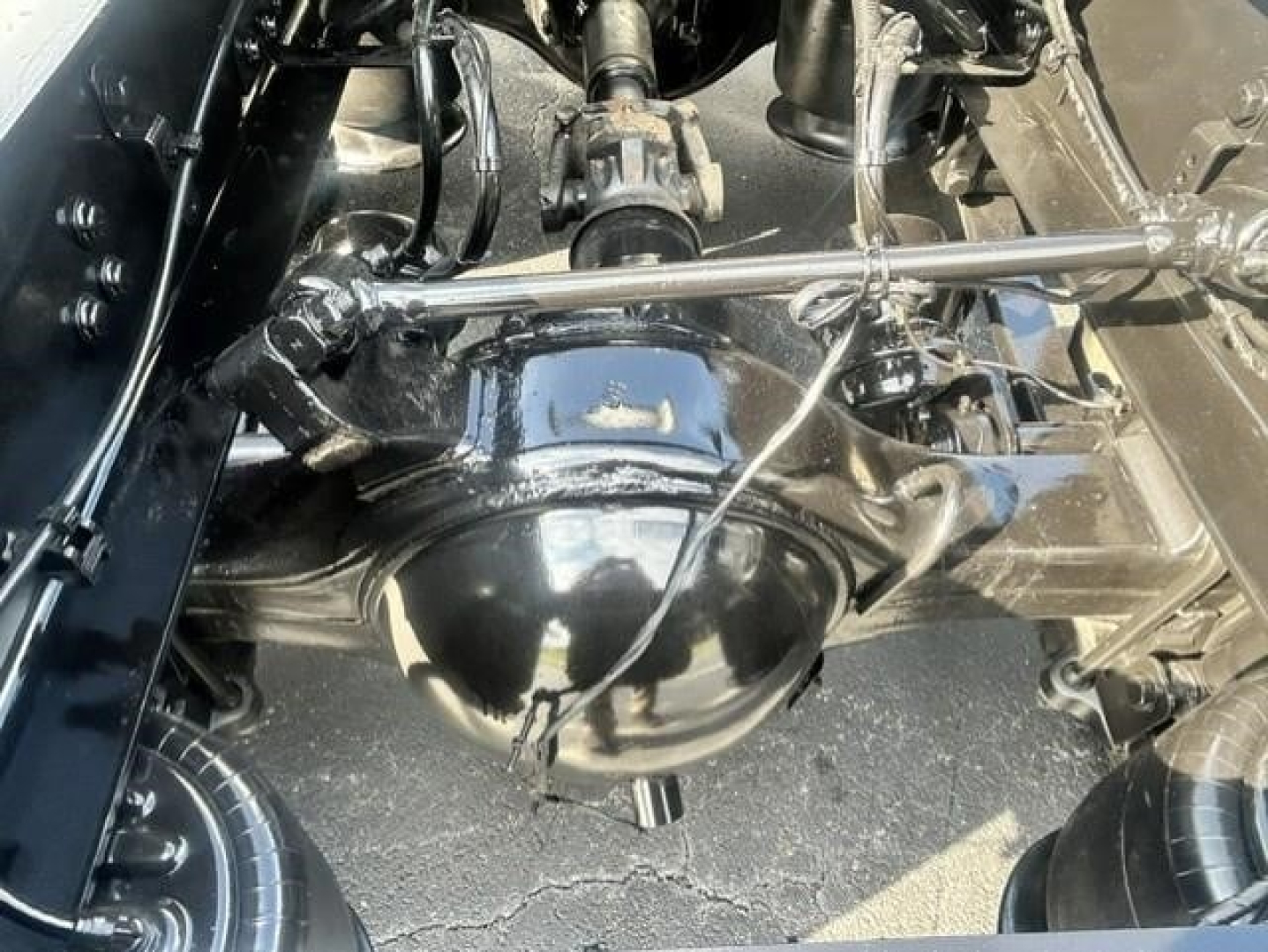 Rear view of Freightliner Cascadia axle hub and suspension components showing differential housing and driveline linkage.