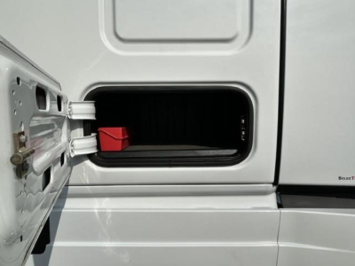 Truck cab door with an open storage compartment showing a red block inside. Exterior silver/gray paint with hinge details.