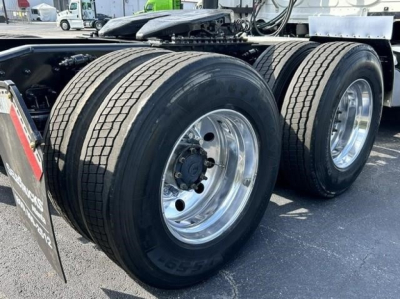 Freightliner Cascadia 126 tractor top view of dual rear axles with large tires and chrome wheels, visible suspension and frame components.
