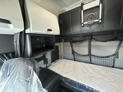 Freightliner Cascadia 126 sleeper cab interior showing bunk bed with mattress and storage nets.