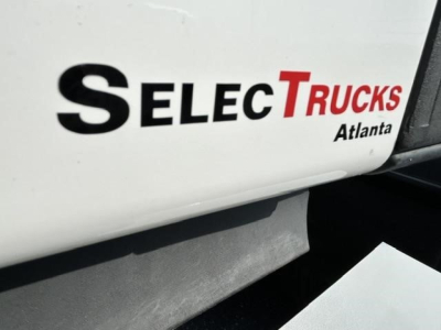 Freightliner Cascadia 126 truck cab side with SelectTrucks Atlanta logo and partial VIN/stock info visible on side