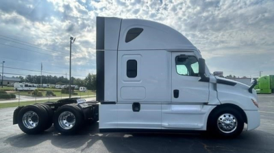 Truck side view showing a 2021 Freightliner Cascadia 126 sleeper cab with chrome wheels and dual rear axles.