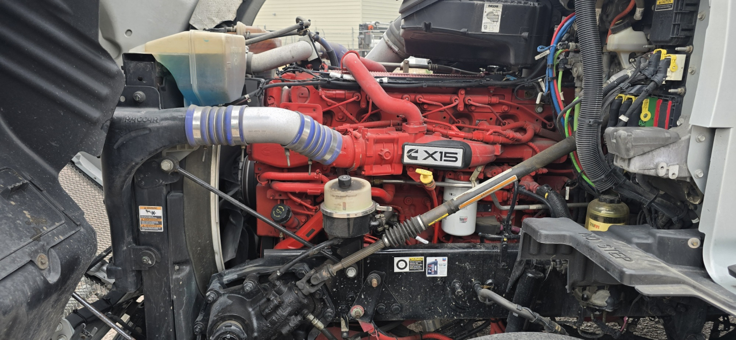 Kenworth T680 engine bay showing X15 engine and surrounding components.