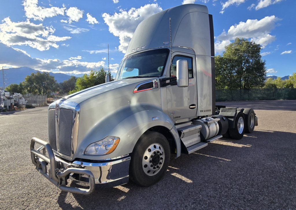 Kenworth T680 conventional daycab truck in exterior view showing chrome grille and dual rear axles with sleeper cab.