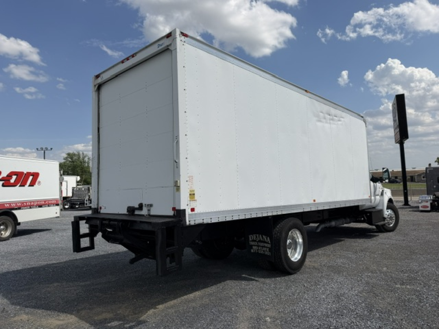 2016 Ford F-750SD box truck rear-left view showing cargo box and dual rear wheels.