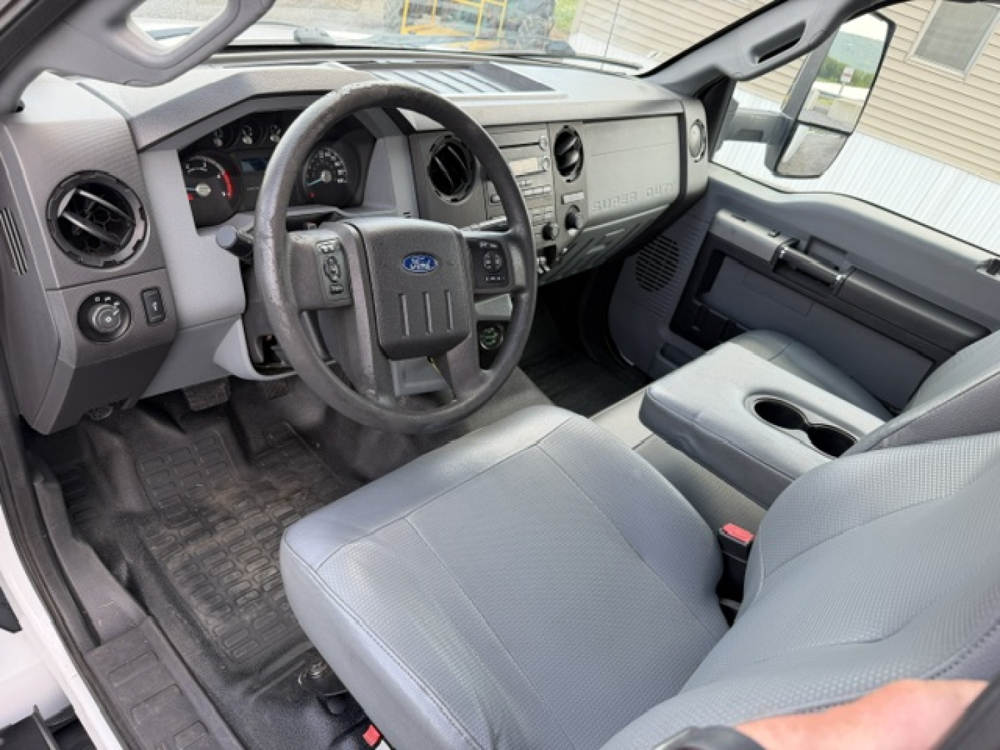 Ford F-750SD cab interior showing steering wheel, dashboard, and front seats.