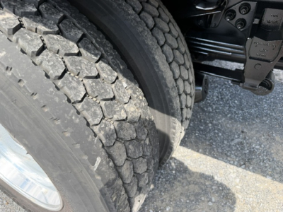 Ford F-750SD truck wheel and chassis view showing heavy-duty tire tread and suspension components.