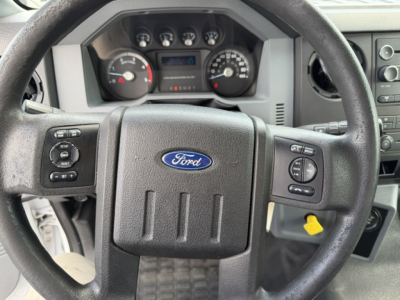 Ford steering wheel and instrument cluster in a 2016 Ford F-750SD cab showing steering wheel with Ford emblem and gauge cluster/