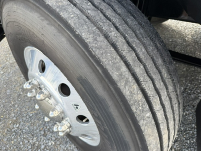 Ford F-750SD truck wheel and dual rear tire showing aluminum rim and tread pattern in a vehicle listing image.