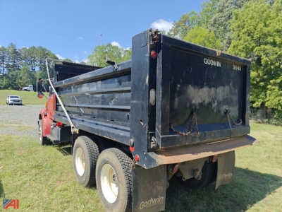 Ford Louisville 8500 dump truck inprofile showing dump bed and rear tailgate with Godwin branding and dual rear wheels.
