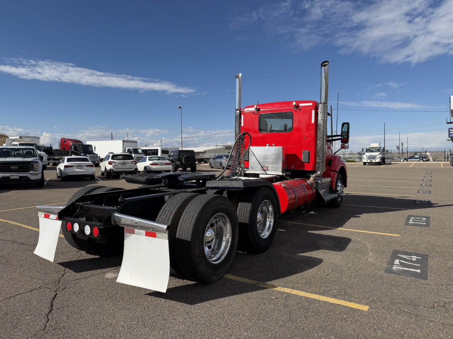 Kenworth T880 truck in a parking lot rear view showing tandem axles and mud flaps