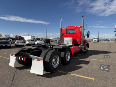 Kenworth T880 truck in a parking lot rear view showing tandem axles and mud flaps