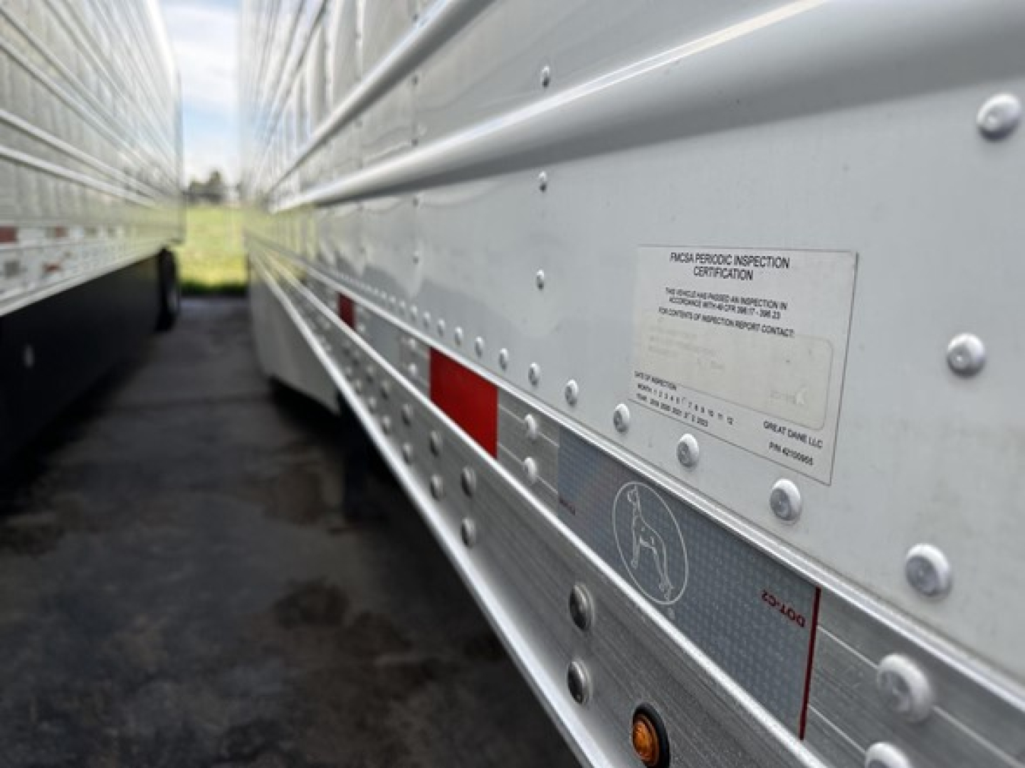 Great Dane 7300 reefer trailer side view showing inspection sticker and riveted aluminum wall.