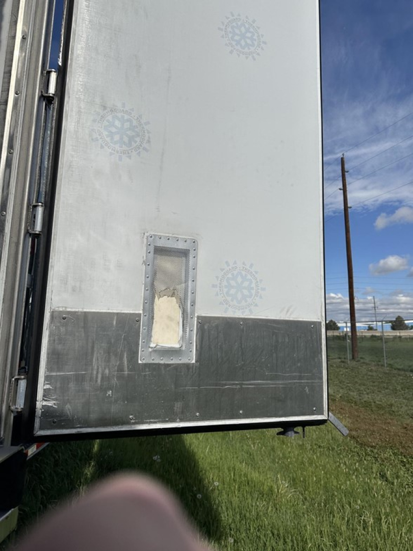 Rear interior wall of a Great Dane carrier trailer showing a recessed access door panel and metal lower panel.