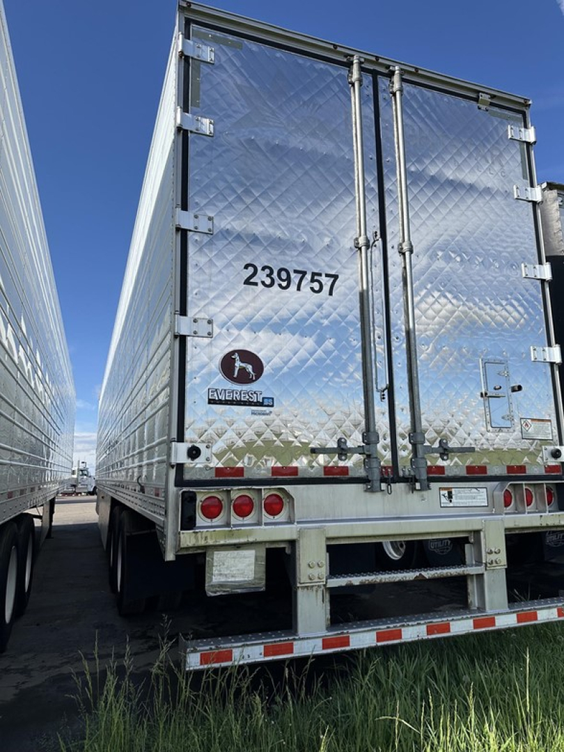 Rear view of a Great Dane carrier trailer with diamond plate aluminum doors, dual rear doors, number 239757, and taillights.