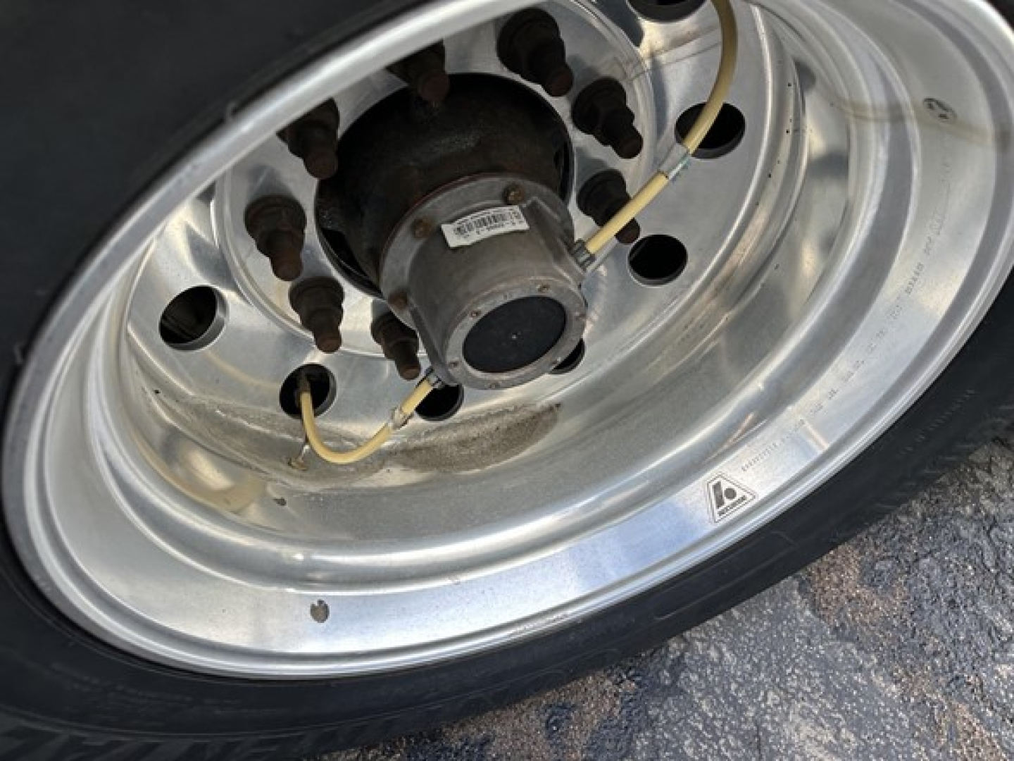 Great Dane carrier trailer wheel hub showing tire and axle components with valve stem and small label on hub.