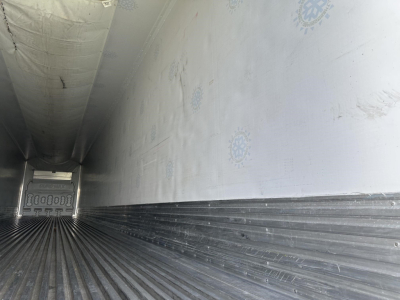 Great Dane air ride reefer trailer interior with ribbed floor and insulated side walls, view from inside toward the rear door.