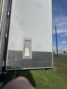 Rear interior wall of a Great Dane carrier trailer showing a recessed access door panel and metal lower panel.