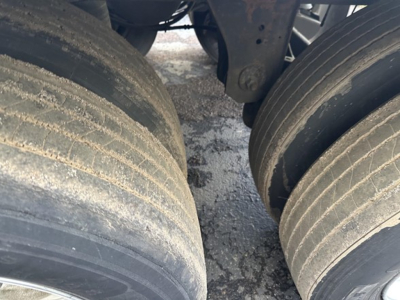 Great Dane Carrier 7300 trailer axle with dual tires and surface dust.