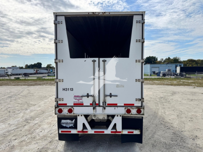 Rear view of a white 2014 Wabash chip trailer showing open loading chute and rear doors, bumper with lights, and stock number H313 with VIN sticker.