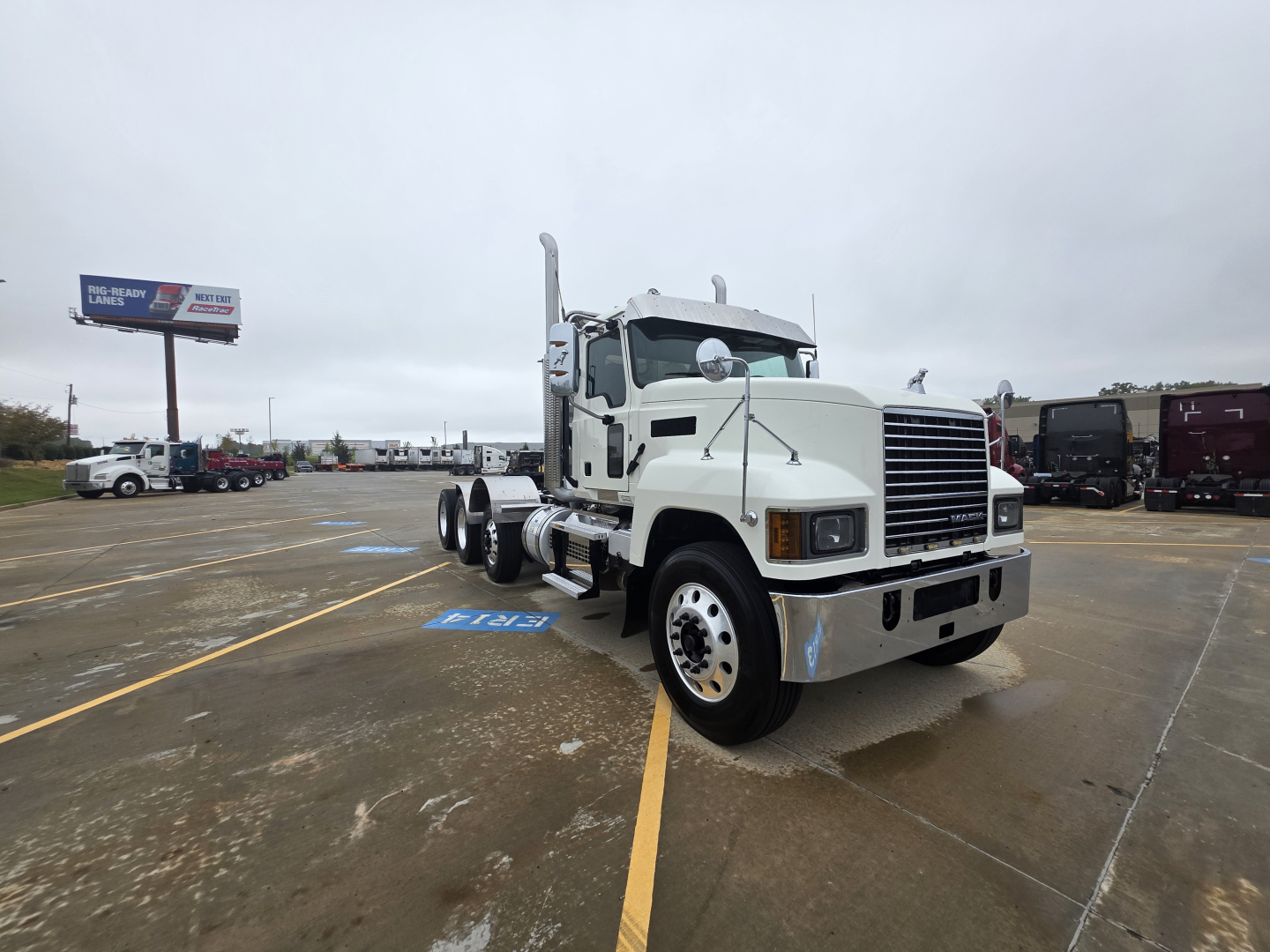 2020 Mack Pinnacle 64T truck in a parking lot with cab and chassis, front view, slight right angle. Text visible includes: no clear model text on grille, tires, vehicle in white with chrome accents.