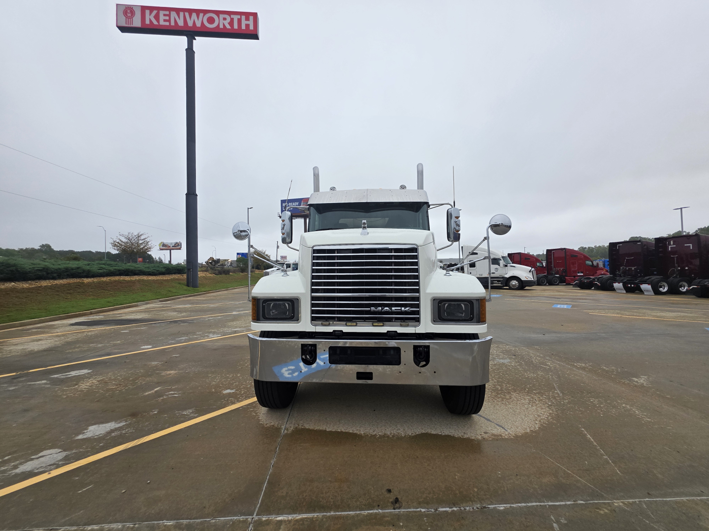 Front view of a 2020 Mack Pinnacle 64T conventional daycab truck in a dealership lot showing grille, bumper, and Mack emblem.