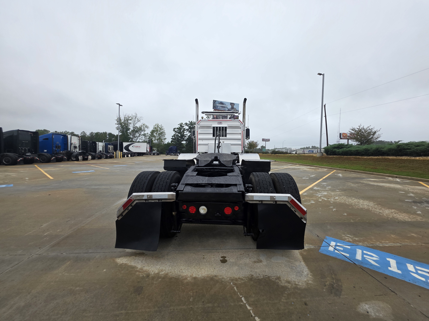 Mack Pinnacle 64T truck rear view showing fifth-wheel and dual rear axles.