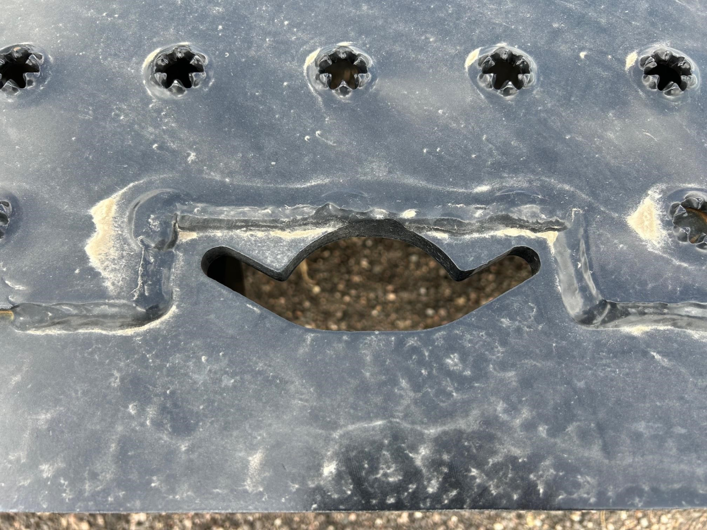 Trail-Eze TE80HT trailer hitch area with black painted metal, riveted plates, and a curved cutout opening.