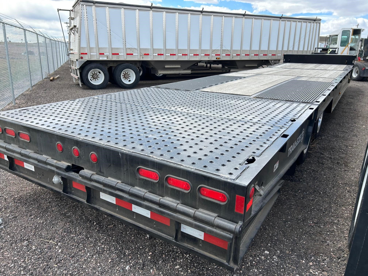Te80Ht trailer deck showing perforated steel surface with tie-down points and rear lighting.