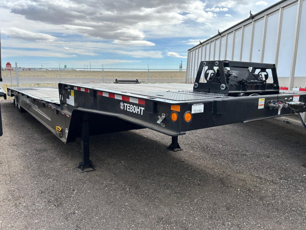 TE80HT Trail-Eze flatbed trailer showing front hitch and black steel frame with a Diamond plate deck and logo TE80HT.