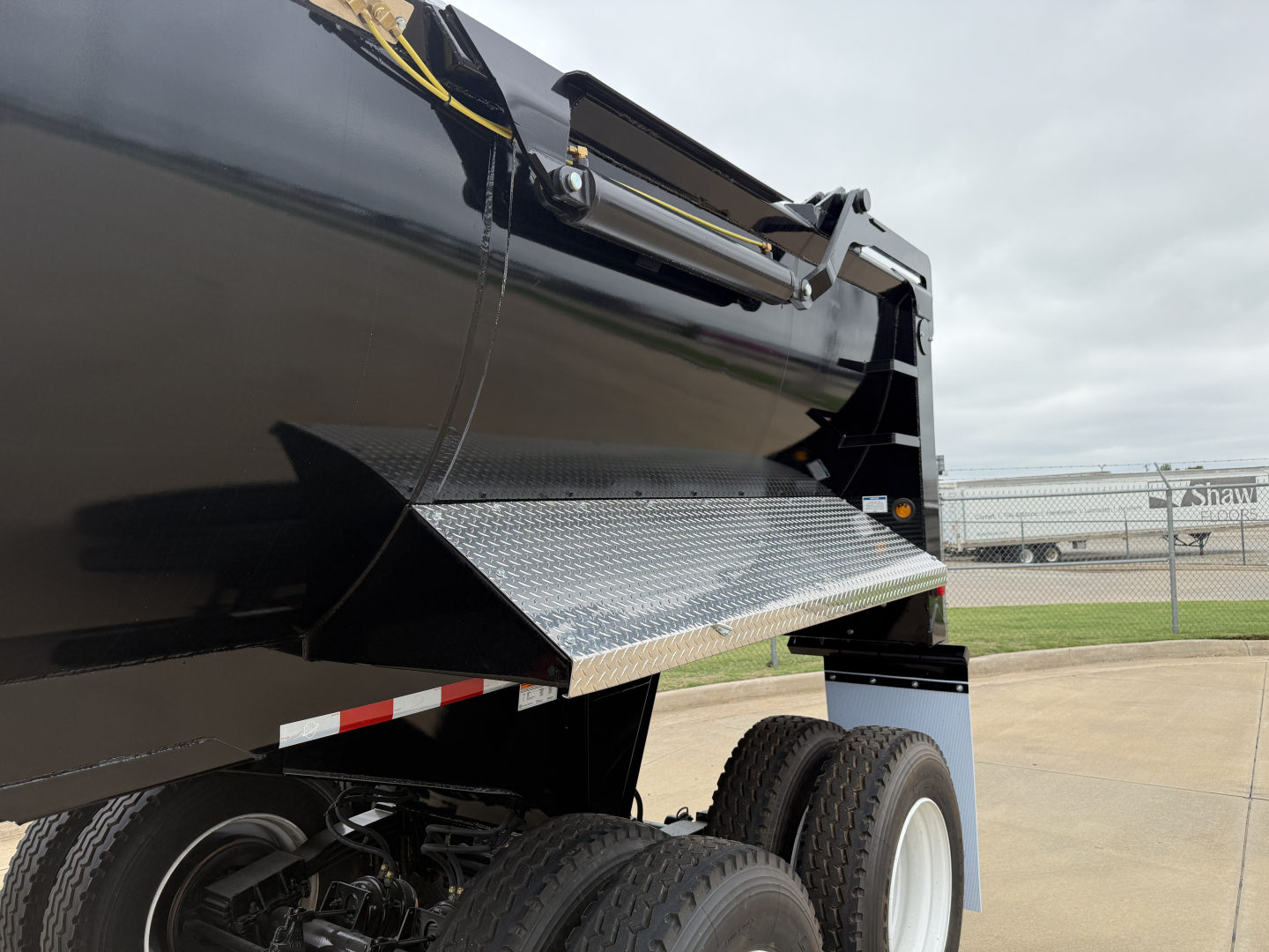 Armor Lite SHD32/48 dump trailer side view showing aluminum diamond plate entry step and dual rear tires.