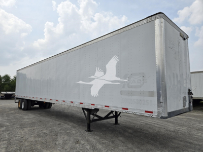 Trailer side profile showing a Vanguard logo and a long silver aluminum trailer with support legs extended, no visible license plates or occupants.
