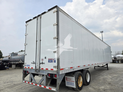 Trailer end and side view of a 2017 Vanguard VXP box trailer with dual rear doors, silver exterior, red/white reflective tape, and tandem axles.